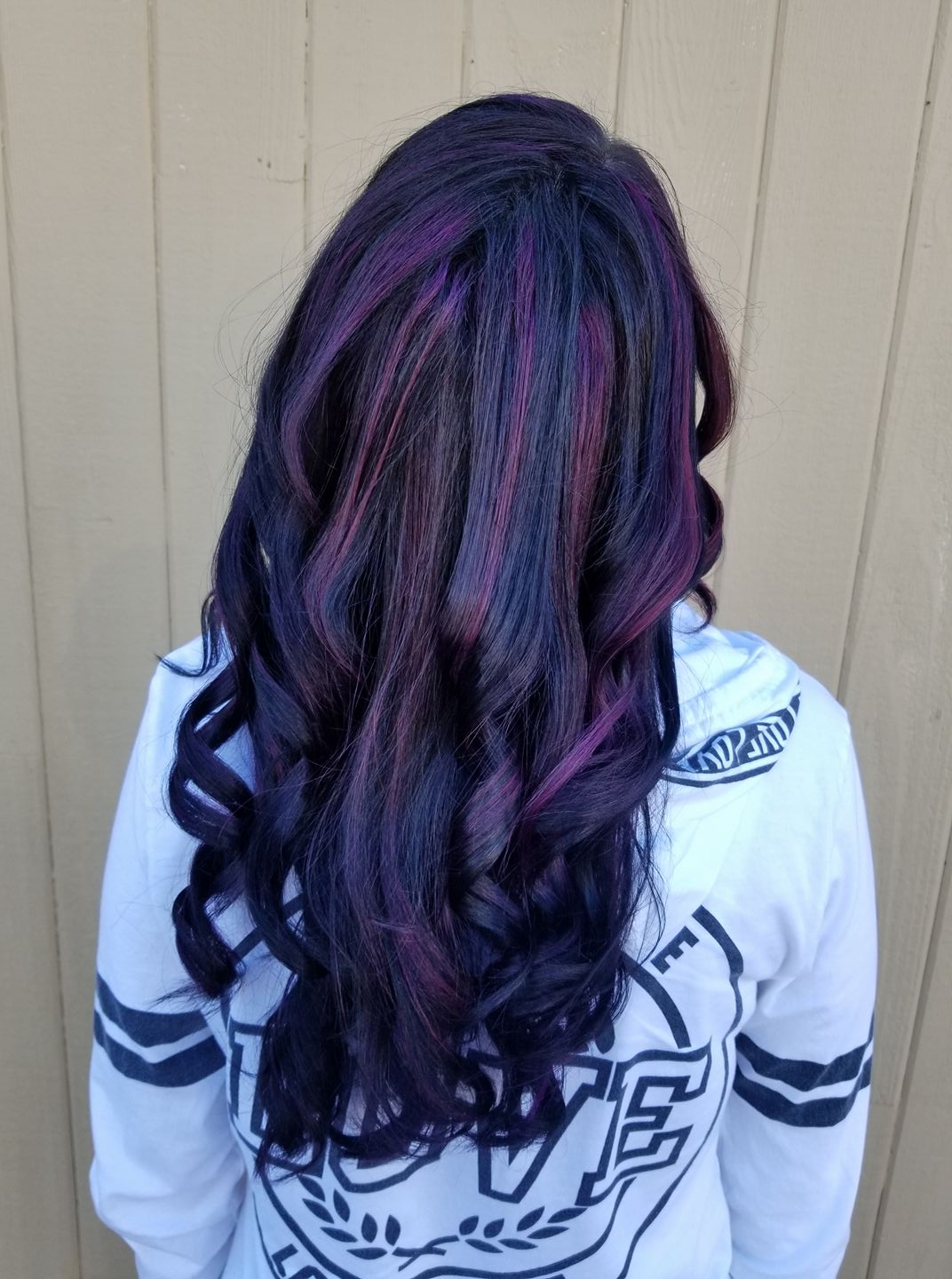 Black hair with vivid magenta and purple highlights