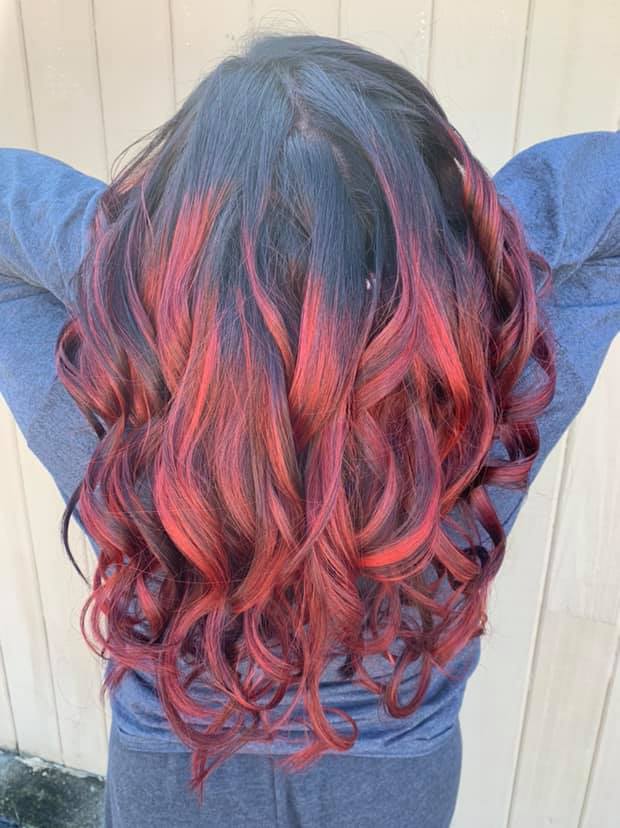 Black hair with bright red peekaboo highlights